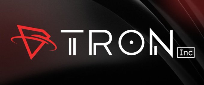 The image features a logo for a company named TRON Inc., which also sells TRX cryptocurrency coins. The logo includes the company name "TRON" written in white letters against a black background with a red triangle at the bottom. The text "Today, the company bought an additional 153,717 TRX @ $0.3224, pushing total holdings over 701.5 million TRX." This information is related to the current price of TRX at the time of viewing the image.