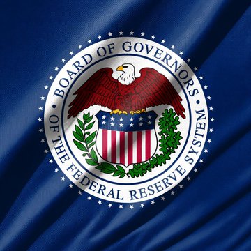 The Federal Reserve's flag displays its official seal featuring an eagle perched above a shield, encircled by the text "BOARD OF GOVERNORS OF THE FEDERAL RESERVE SYSTEM," symbolizing the central bank's authority as it moves forward with implementing stablecoin regulations.
