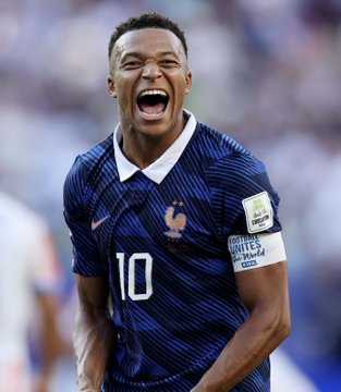 Kylian Mbappé, wearing France's number 10 jersey, celebrates exuberantly after a goal. The image ties to the post highlighting his 37% odds of winning the official World Cup Golden Ball, making him the favorite among players like Messi, Kane, Haaland, and others ahead of the quarterfinals.