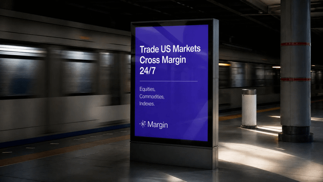 The image shows a large advertisement for a new Margin Trading platform, with an indoor train station as its backdrop. The billboard displays various text elements, such as "Trading US Markets" and "Equity", which suggests that this platform connects users with potential trading opportunities in the United States' markets. Additionally, there is information about the nature of these transactions: "solana-native perpetual futures". This implies that traders can utilize native solana addresses to execute transactions on this trading platform.