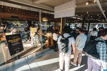 A group of attendees gathers outside a "Horsefeather" restaurant for a meetup event, with a sign in the window welcoming guests to the "Meetup Tonight." The crowd outside reflects the appreciation for those who joined the successful gathering.