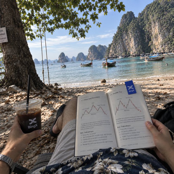 A person relaxes on a tropical beach reading a "Trading Patterns" book with visible sections "4.1 Head and Shoulders" and "4.2 Double Top," while holding a BingX-branded iced coffee, with longtail boats and limestone cliffs in the background—pairing a tranquil vacation scene with trading study, echoing the idea that there's always a page worth coming back to.