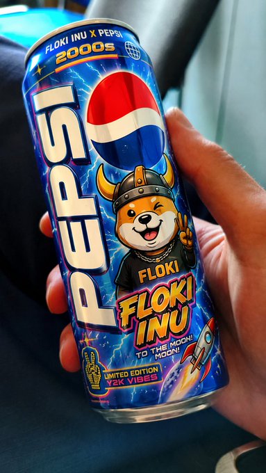 A hand holds a limited edition Pepsi can featuring 'FLOKI INU' branding, Floki the dog mascot in a viking helmet, and text reading 'FLOKI INU X PEPSI', '2000S', 'TO THE MOON MOON!', and 'LIMITED EDITION Y2K VIBES'.