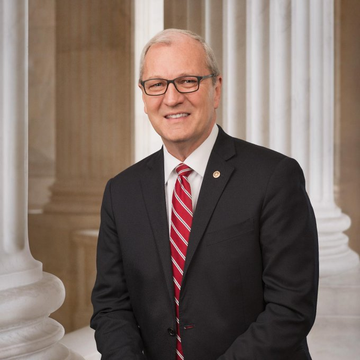 Senator Kevin Cramer is pictured with columns in the background, as he discusses the CLARITY Act's progress toward the August recess for crypto market advancements.
