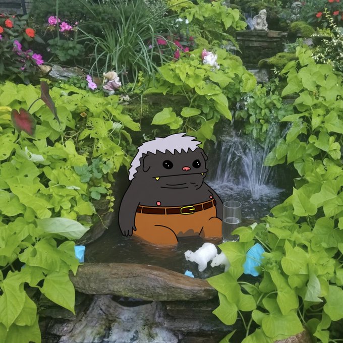 An animated gray cartoon character wearing a diaper and brown pants stands in a lush garden pond beside a waterfall, surrounded by small figurines and a tiny glass of water, echoing the "$hobibi" character's quirky, unbothered charm and whimsical lifestyle.