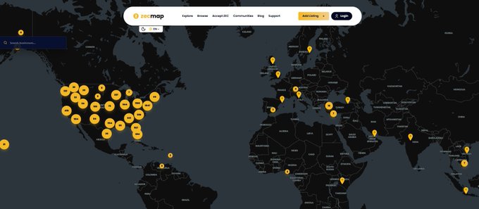 A world map showing the ZOOMAP website with numerous Bitcoin logos clustered across North America, Europe, and other regions, indicating ATM or merchant locations.