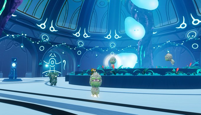 Screenshot from a video game showing a blue-toned futuristic temple or shrine with glowing symbols, floating orbs, and small mossy stone characters with flowers on their heads.