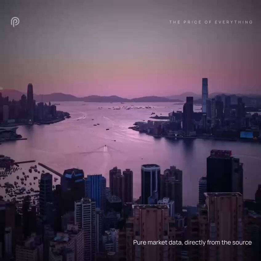This image depicts a cityscape with a large body of water running through its center, surrounded by tall buildings. The sky above them is painted in shades of pink, indicating that the photograph was taken during either sunrise or sunset. At the bottom of the image, there is text talking about the price of everything and how it is now live on @PythNetwork Pro.