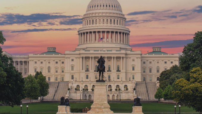 A scenic photograph of the United States Capitol Building in Washington D.C. at sunset, showing the illuminated dome, the front facade, and the Ulysses S. Grant Memorial statue in the foreground.