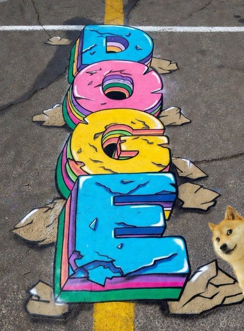 Colorful 3D-style graffiti art spelling 'DOGE' on asphalt, with a Shiba Inu dog visible in the bottom right corner.