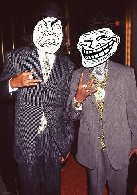 Two men in suits pose together, their faces obscured by black-and-white cartoon 'rage face' and 'troll face' internet meme masks.