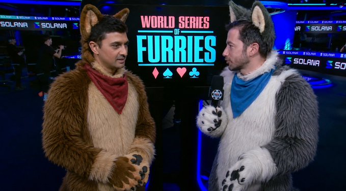 Two people wearing furry animal costumes stand on a stage at the 'World Series of Furries' event, with Solana branding visible in the background.