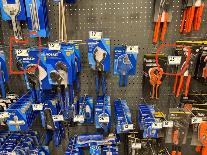 A retail display of hardware tools features Kobalt and Raider brand pruning shears with visible price tags reading 29, 19, 16, 25, 39, 23, 26, 13, and 10.