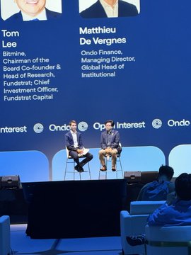 Two men sit in a panel discussion at an "Ondo" event, identified on the backdrop as Tom Lee (Bitmine Chairman, Board Co-founder & Head of Research, Fundstrat; Chief Investment Officer, Fundstrat Capital) and Matthieu De Vergnes (Ondo Finance, Managing Director, Global Head of Institutional). The image playfully positions these two financial figures as the gatekeepers of 99% of ETH, tying into the caption's teasing question about who holds more.
