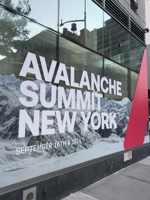A billboard on a glass building advertises the "Avalanche Summit New York" event scheduled for September 16th and 17th, featuring a snowy mountain backdrop and red triangular logo. This visual sets the scene for the post's poetic "night before" announcement, welcoming attendees to the upcoming gathering in NYC.