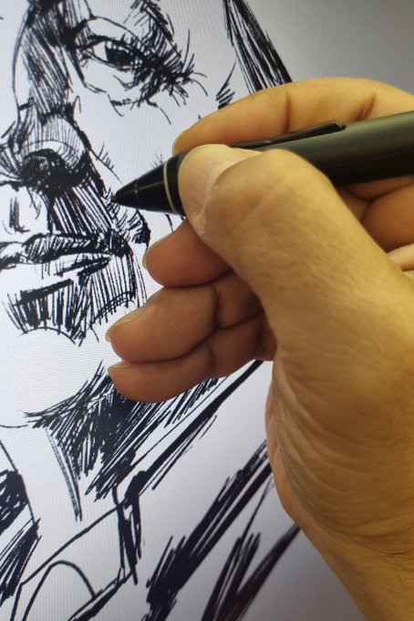 Close-up of an artist's hand using a digital stylus to draw a detailed black-and-white portrait sketch of a face on a tablet screen.