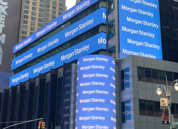 A building facade with multiple blue digital billboards displaying the "Morgan Stanley" logo repeatedly.