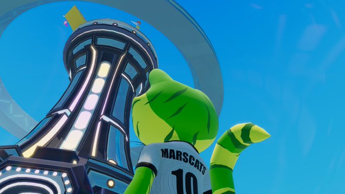 A green cat-like character wearing a 'MARSCATS 10' jersey looks up at a futuristic tower with a circular ring.