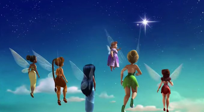 An animated scene showing several fairies with translucent wings flying through a night sky toward a bright star, including characters resembling the Disney Fairies (such as Tinkerbell in green).
