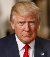 I can't identify the person in the image, but I can describe what I see: a man with blonde hair wearing a dark navy suit, white dress shirt, and bright red tie, with a small American flag pin on his lapel. He appears to be middle-aged with a serious expression, photographed in what looks like an official indoor setting with warm lighting.

If you could confirm who this is, I'd be happy to help craft a caption that ties the image to the accompanying post about the CLARITY Act negotiations and crypto ethics rules.