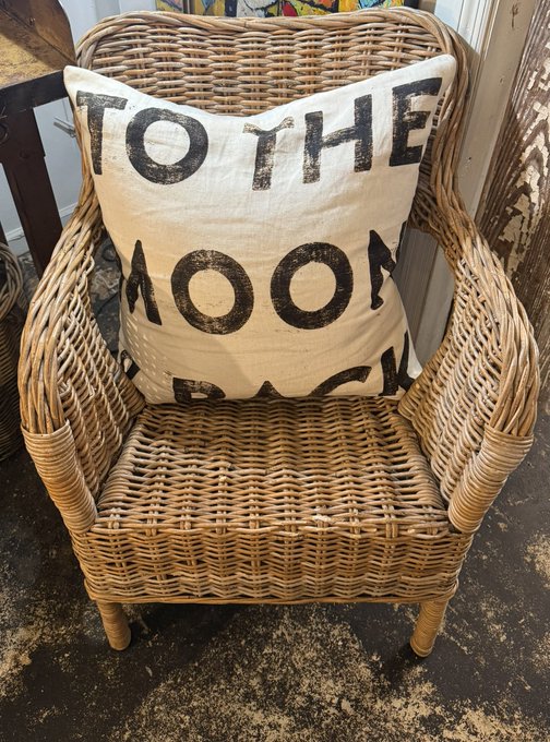 The image features a wicker chair with a white pillow that says "To The Moon Back" written on it, along with some text about XRP family safety.