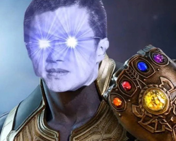 A digitally altered image shows a man's face with glowing white eyes emitting purple beams, alongside the Infinity Gauntlet featuring all six glowing stones, evoking the "Thanos snap" from Marvel's Avengers. The caption "Soon... Liquidation is inevitable" references Thanos's famous line "I am... inevitable," humorously repurposing it as a menacing financial warning of an impending market crash.