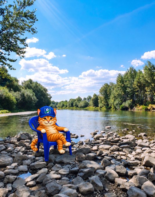 An AI-generated image of an orange tabby cat wearing a blue baseball cap and sitting in a blue plastic chair on a rocky riverbank with trees and water in the background.
