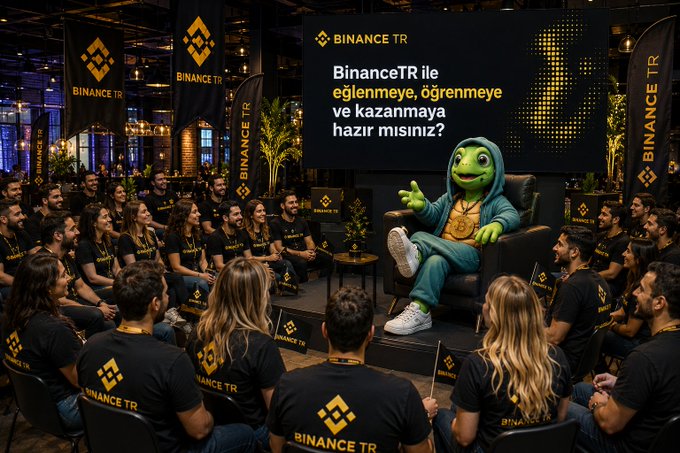 A green mascot in a Binance TR hoodie sits on a stage addressing a crowd of attendees wearing "BINANCE TR" t-shirts, with a large screen behind reading "BINANCE TR - BinanceTR ile eğlenmeye, öğrenmeye ve kazanmaya hazır mısınız?" (Are you ready to have fun, learn, and earn with BinanceTR?), promoting the upcoming Istanbul Meetup event.