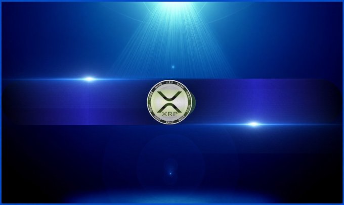 A blue graphic displaying the XRP cryptocurrency logo centered on a dark circular badge, illuminated by dramatic light rays and lens flares against a deep blue background.