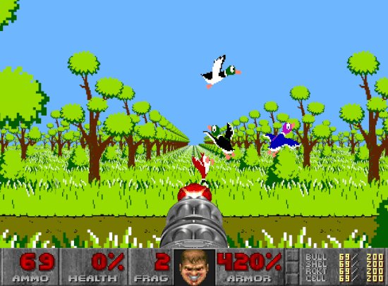The image shows a scene from an old-time shooting game, featuring a gun with a man's face on its barrel. A duck is flying above the gun, while two other ducks are also present in the scene. The background of the image includes trees and grass, creating a natural setting for the game. The post about the game is written in white text at the bottom right corner of the image.