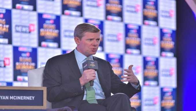Visa CEO Ryan McInerney, pictured here at a CNBC event, speaks into a microphone while gesturing with his hand as he discusses the company's "multi-coin, multi-chain" stablecoin strategy.