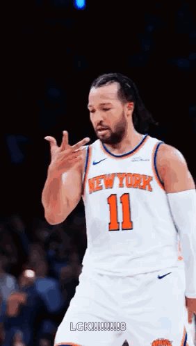 The image features a basketball player wearing an orange and white jersey with the number 11, standing on a court and making a peace sign gesture with his fingers. The caption of the image includes the name "LemzETH" which might be a reference to the basketball team or player's last name.