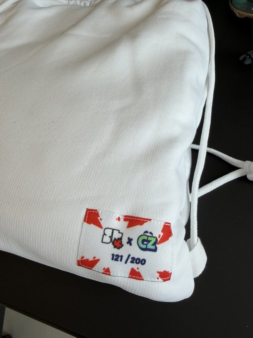 A white drawstring bag featuring a custom label reading '83 x CZ 121/200' with red maple leaf graphics, indicating a limited edition collaboration item.