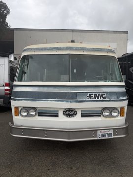 A vintage white and gray GMC motorhome (license plate GJ-W9788) is parked in a lot, humorously dubbed "$MULLET" in the caption—playing on its busy "business in the front, party in the back" appearance, or perhaps a nod to its boxy, retro styling.