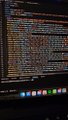A blurry screenshot of lines of code on a screen, likely depicting the programming work behind the "HOOD RUN" mobile/PC game built for the $HOODIE community featuring a pixel flying character based on @0FJAKE's profile picture.