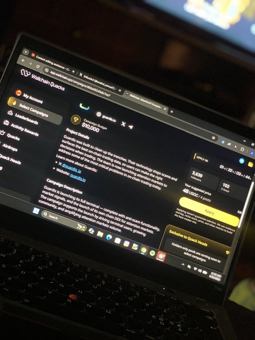The image shows an open laptop screen displaying a webpage with information about a campaign creator. The text on the page indicates that the creator has met the minimum X score required for application, as indicated by the phrase "i just applied for the creator campaigns on @wallchain". This suggests that the user is likely to be notified of their acceptance or rejection in the upcoming review process.