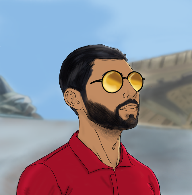 The image features a man wearing red clothing, including a shirt with a collar and a tie around his neck. He has a beard and is wearing glasses. The background of the image shows a road or street scene, which could be an outdoor setting like a park or a city street. There are also some cars visible in the background.