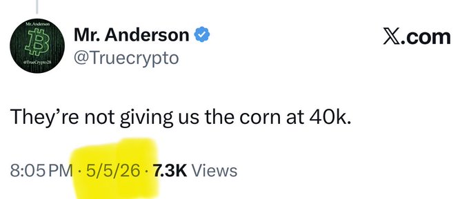 A tweet from Mr. Anderson (@Truecrypto) on X.com dated 5/5/26 reads "They're not giving us the corn at 40k," with 7.3K views and a yellow highlight over the timestamp. The caption "It was never happening!" reinforces the post's sarcastic tone, suggesting the speaker always doubted a 40k price target (likely Bitcoin) would be reached.