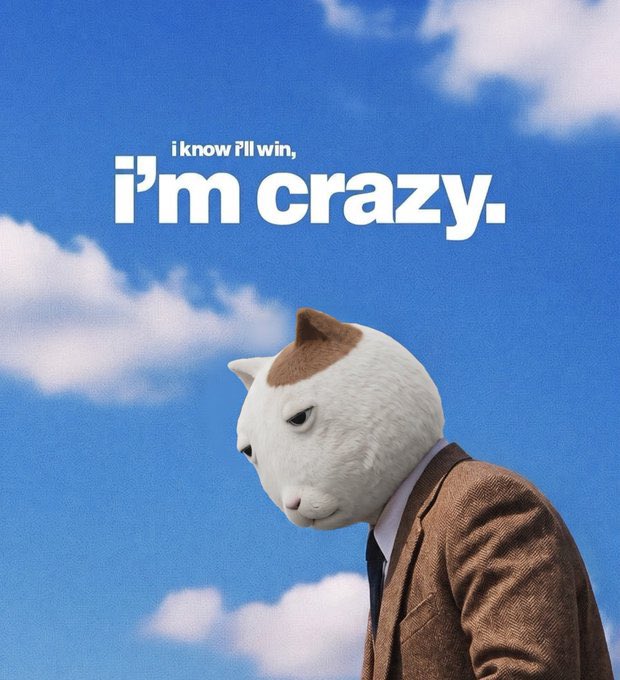 The image shows a person wearing a realistic white cat mask with brown ears, dressed in a brown herringbone suit and white shirt, set against a blue sky with scattered clouds. Bold white text at the top reads, "i know i'll win, i'm crazy."—capturing the fearless, confident energy needed to welcome the bull season.