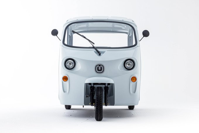 A three-wheeled light blue mobility vehicle, featuring the "Musubi" logo (a stylized "U") on its front grille, is displayed against a white background.

The image showcases a small electric three-wheeler branded with the Musubi logo, visually reinforcing the post's message about providing vehicle financing for mobility workers worldwide.