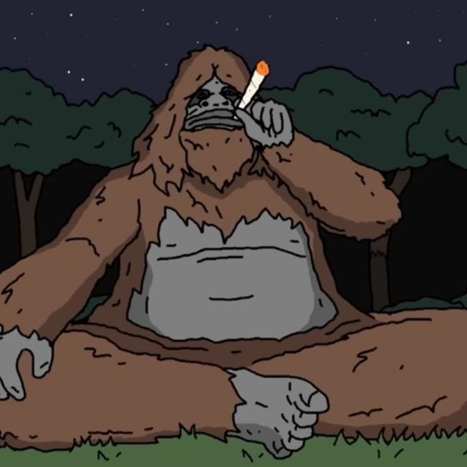 A cartoon illustration of a large brown Bigfoot/Sasquatch creature sitting cross-legged in a forest at night, smoking a lit cigarette.