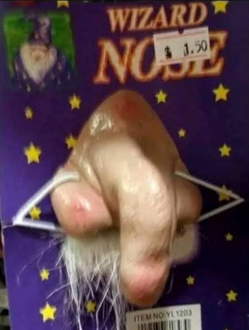 A retail package for a 'Wizard Nose' novelty costume priced at $1.50, featuring a long, fake pointed nose and white beard attached to a purple card with gold stars.