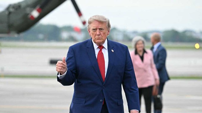 Donald Trump gives a thumbs up while walking on an airfield, seemingly acknowledging the announcement that the SEC Chair is working to bring Hyperliquid into the US.