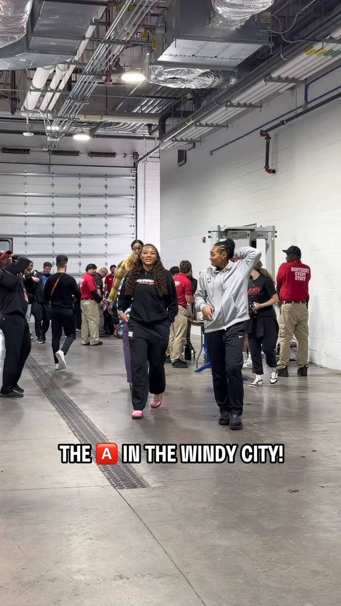 The image shows a group of people standing inside a building, possibly an arena or warehouse, with some of them holding skateboards. The caption for the image reads "ATL has entered the chat The @ AtlantaDream are in the building and ready for Comm Cup action vs. the Sky! 7pm/ET on ESPN". This suggests that there is a skateboarding event taking place inside the building, possibly at an arena or warehouse.