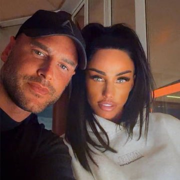 A man in a black cap and dark shirt takes a close-up selfie alongside a woman with long dark hair and a white top, appearing relaxed together. The image likely shows Katie Price with the man referred to in the post—the husband she reportedly left after his supposed $50M crypto wallet was found to contain only $3.