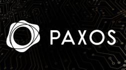 The image shows the "PAXOS" logo, featuring the company's distinctive symbol of overlapping rings alongside its name, displayed against a dark circuit board background. This branding relates directly to the post, which announces that Paxos-issued USDG stablecoin has launched on Arbitrum as part of the Global Dollar Network.
