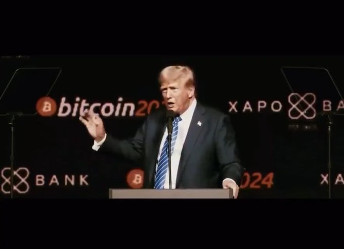Former U.S. President Donald Trump speaking at a podium at the Bitcoin 2024 conference, with 'bitcoin 2024' and 'XAPO BANK' logos visible on the dark backdrop.