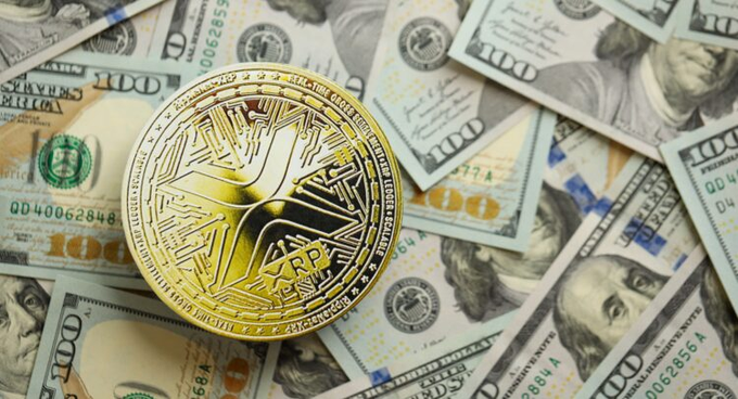 The image features a gold coin, possibly a Bitcoin or Ripple token, sitting atop a pile of US dollar bills. The coin appears to be larger than the surrounding money, drawing attention to its presence. The text in the image reads "THE XRP LEDGER IS ABOUT TO INTEGRATE OVER 5 MILLION STORES/MERCHANTS!! $10,000 !!! HOLY SH*T!! JUST BOUGHT A BAG OF REAL TOKEN ON XRPL!!!". This message suggests that the coin has been recently minted and is now being integrated into a larger system or project.