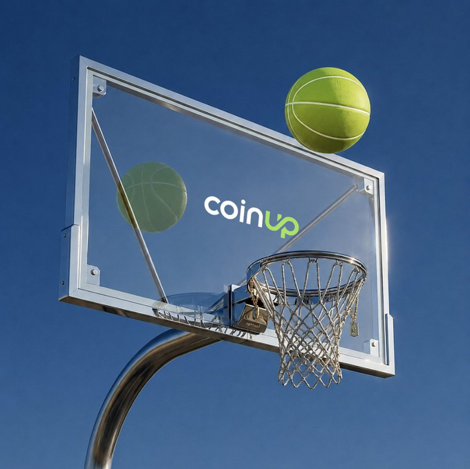 The image features a basketball hoop with two green balls sitting on top of it against a blue sky background, which appears to be a sunny day. The text "CoinUp fam" can also be seen in the image.