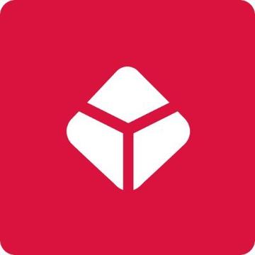 The image shows a red app icon featuring a white stylized cube or diamond logo, representing the Blockchain wallet application. This icon corresponds to the post announcing Blockchain's integration of Polymarket's prediction market platform into its global mobile interface, allowing users to trade on real-world outcomes directly within their wallet app.